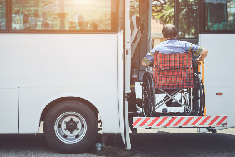 Disabled people sitting on wheelchair and going to the public bu Disabled people sitting